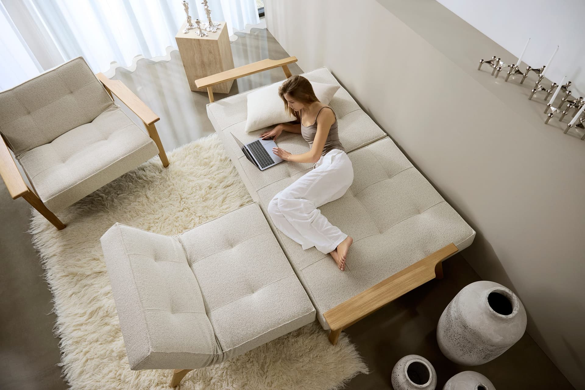 Cubed sovesofa med eikeben i stue med moderne veggkunst